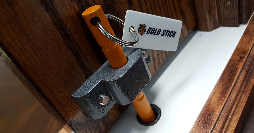 Bolo Stick steel pin set through the door bracket into the floor plate